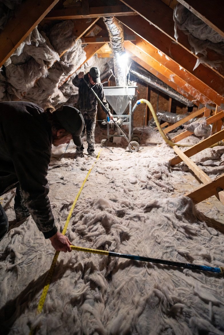 Attic insulation contractor inspecting an attic before providing a quote